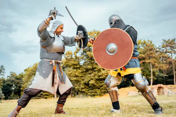 Two knight with chain mail armor fighting for dignity and to protect the kingdom