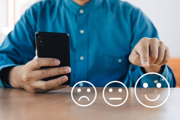 Businessman use smartphone giving rating with happy icon, Customer satisfaction survey concept Businessman use smartphone giving rating with happy icon, Customer satisfaction survey concept consumer confidence photos stock pictures, royalty-free photos & images