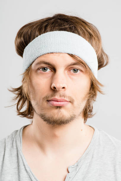 istock Shot of a handsome young man standing alone in the studio and posing while wearing a headband 1387670943