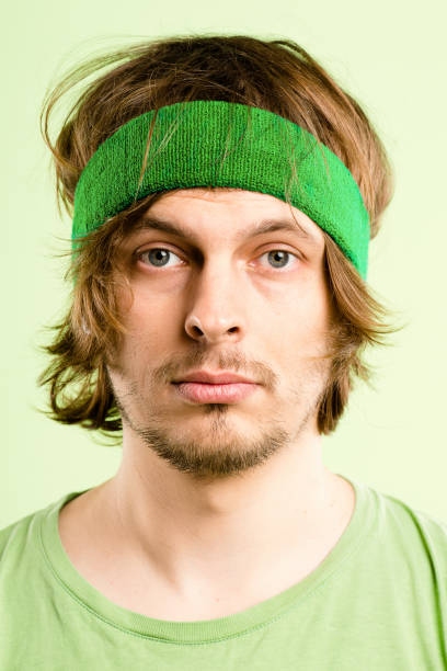 istock Shot of a handsome young man standing alone in the studio and posing while wearing a headband 1387670989