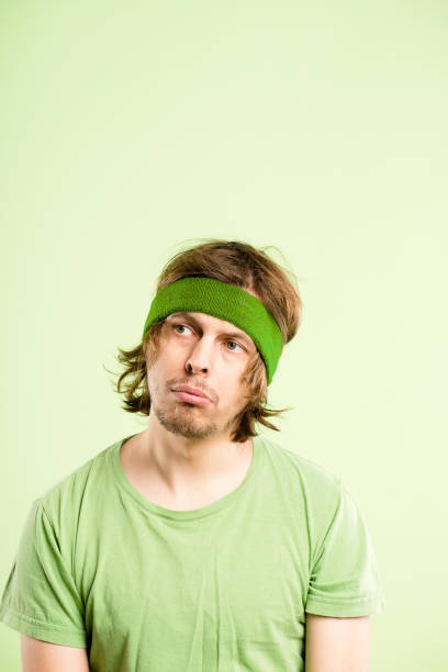 istock Shot of a handsome young man sitting alone in studio and looking contemplative 1387671000