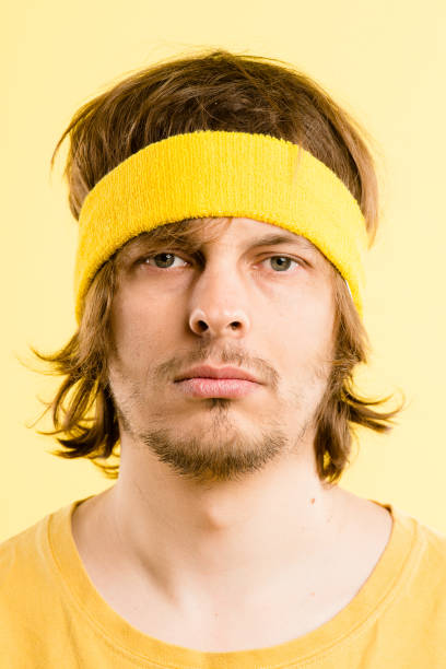 istock Shot of a handsome young man standing alone in the studio and posing while wearing a headband 1387671023