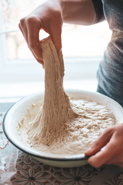 istock Kneading yeast dough for baking, sourdough. Home baking recipe. 1387672834