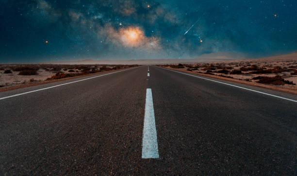 istock road in the desert at night 1387675075