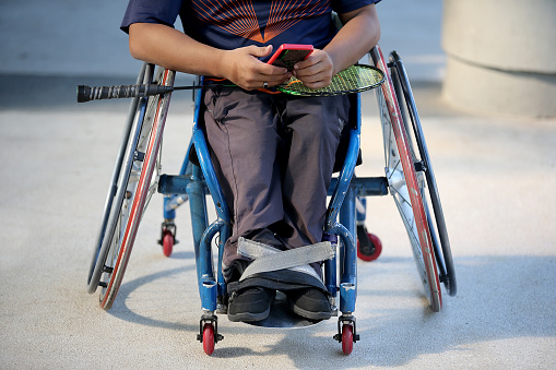 Close-up on wheelchair straps on feet for support.