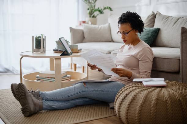 istock Woman at home paying bills online 1387676356