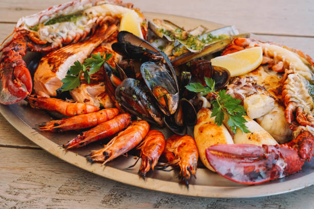 un délicieux barbecue de fruits de mer avec moules, crevettes et homard - food shrimp barbecue grill seafood photos et images de collection