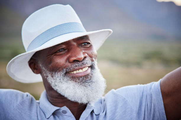 istock Stylish mature man smiling while enjoying a day outdoors 1387681682