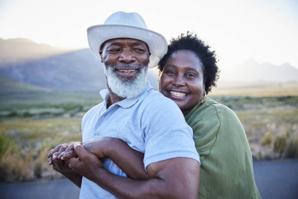 istock Smiling woman hugging her husband during a sunny day outside together 1387682892