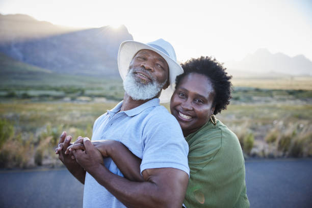 istock Smiling woman hugging her husband during a sunny day outdoors together 1387682929