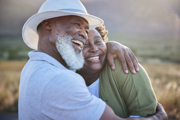 istock Mature couple laughing and hugging each other outside in summer 1387684314