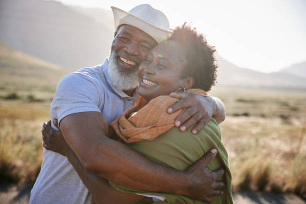 istock Smiling mature couple hugging during a day outdoors in nature 1387685088