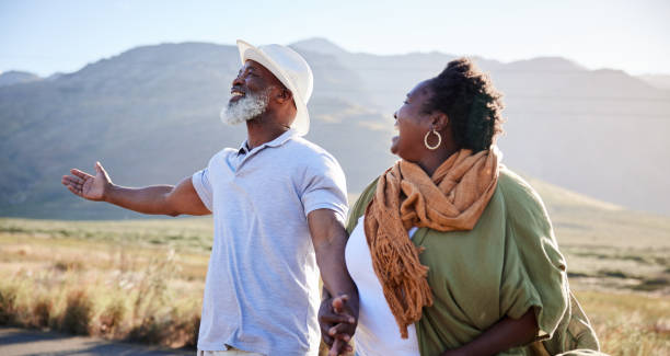 istock Mature couple laughing while enjoying a day outdoors in nature 1387685149