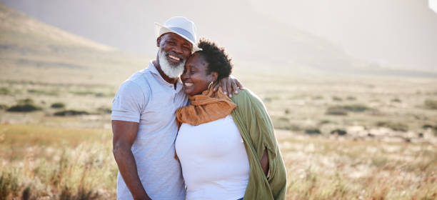 Loving mature couple standing together outside in nature stock photo