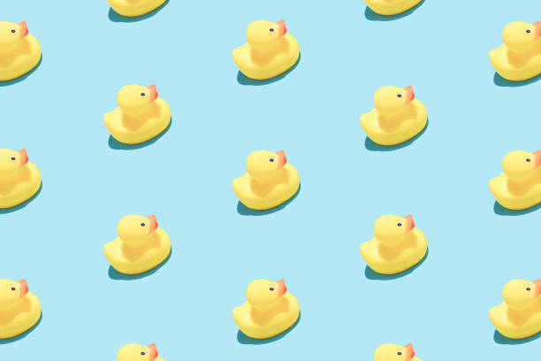 istock Trendy pop art design of a yellow rubber duck pattern from a top view. 1387686063