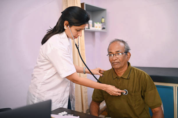istock Female doctor examining senior man with stethoscope 1387686322