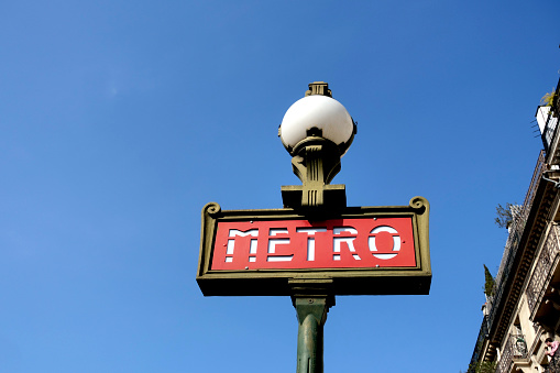Metro sign in Paris, France on blue sky background