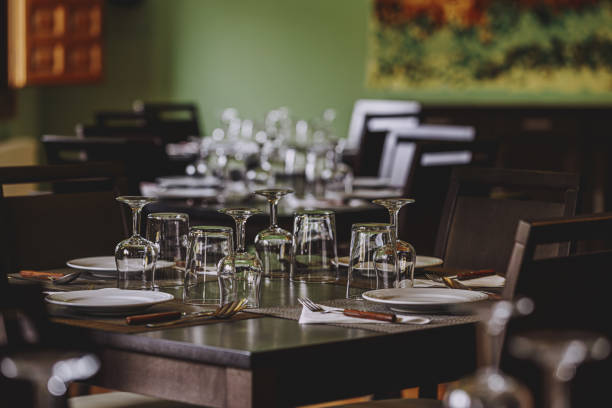 istock Laid table in the restaurant. There are empty wine glasses on the table. 1387690243