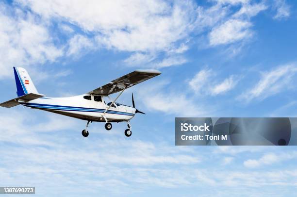 Light Aircraft Flying Over Blue Sky Stock Photo - Download Image Now - Propeller Airplane, Single-Engined Plane, Private Airplane