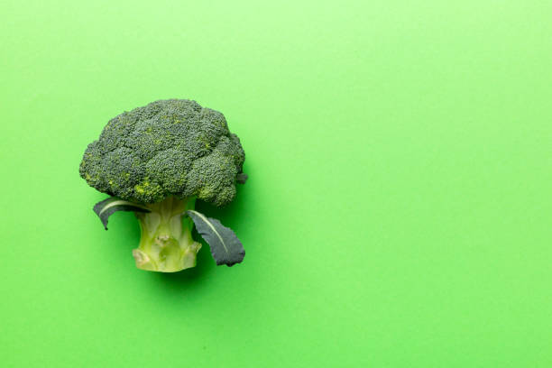 istock Top view fresh green broccoli vegetable on Colored background. Broccoli cabbage head Healthy or vegetarian food concept. Flat lay. Copy space 1387690667