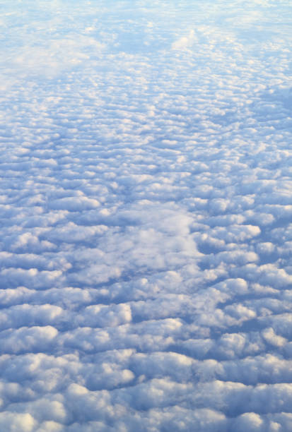 istock Incredible sea of clouds view from the plane window during flight 1387694521