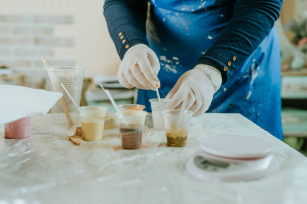 istock Woman prepairing ingredients for making clock in Resin art 1387694778