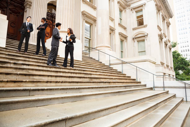 istock Professionals in Discussion on Staircase 1387694808