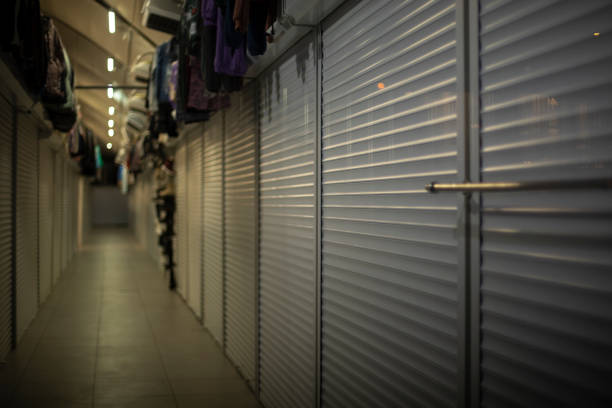 Shops are closed. Shopping arcade. Corridor in shopping pavilion. Territory of clothing market.