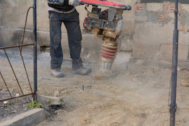 istock Worker uses a portable vibration rammer at construction a formwork for a blind area at home 1387695677
