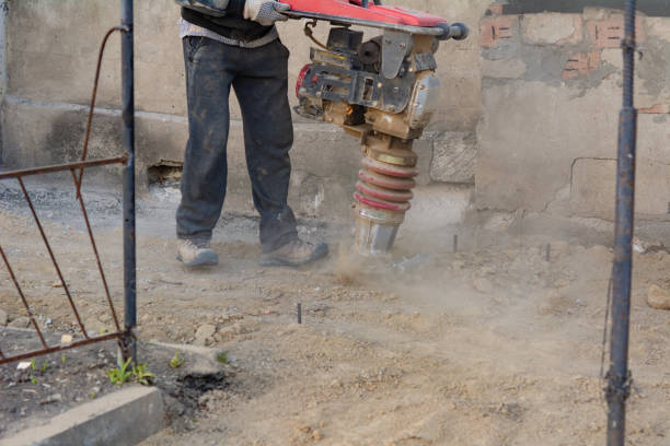 istock Worker uses a portable vibration rammer at construction a formwork for a blind area at home 1387695754