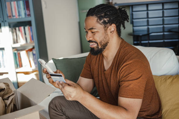 istock Young man using smart phone to shop online 1387696969