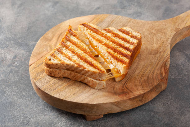 grilled cheese sandwich on gray concrete background grilled cheese sandwich on gray concrete background toasted sandwich stock pictures, royalty-free photos & images