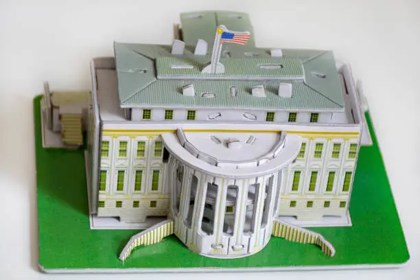 Photo of model of the White House of the President on the background of dollars