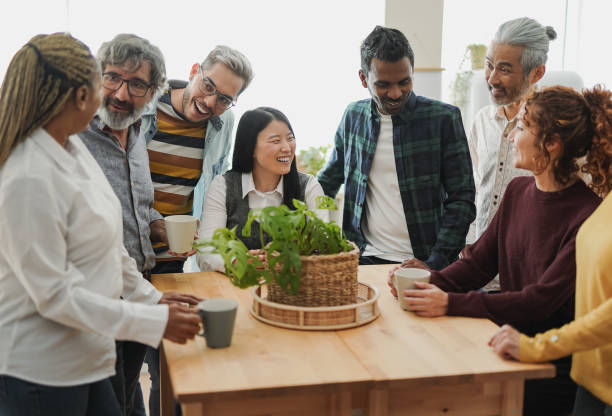 Group of multiracial people drinking coffee together indoor - Multi generational friends concept Group of multiracial people drinking coffee together indoor - Multi generational friends concept age contrast stock pictures, royalty-free photos & images