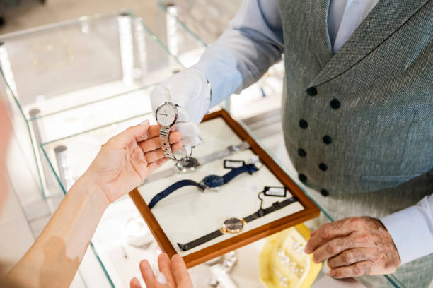 istock Young woman looking at a wristwatch showcase 1387702894
