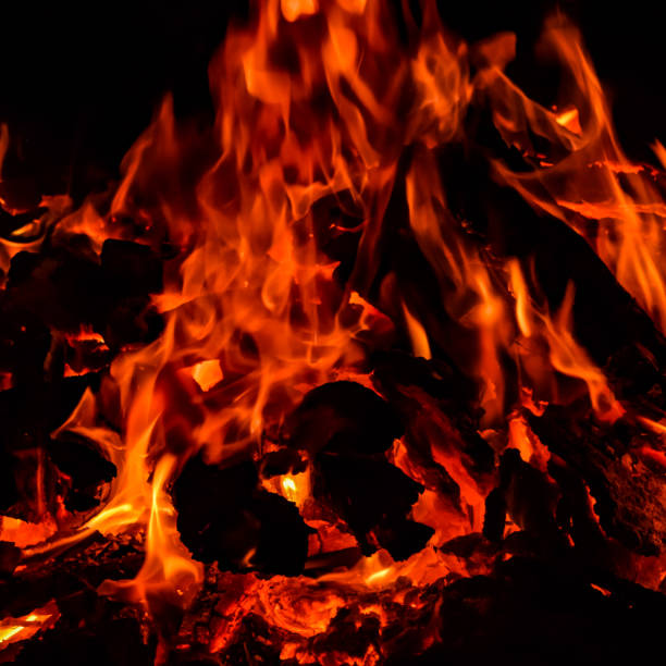 istock Fire flames on black background, Blaze fire flame texture background, Beautifully, the fire is burning, Fire flames with wood & cow dung 1387708901