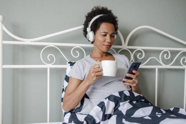 istock Relaxing and drinking morning coffee in bed 1387710146