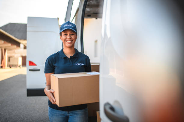 Young Delivery Woman Carrying A Package stock photo