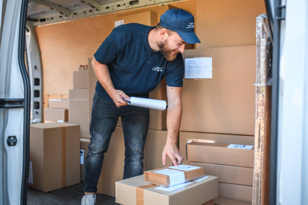 istock Young Delivery Man With Parcels 1387713943