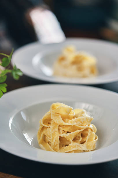 istock Preparing Fettuccine Pasta Alfredo with Parmesan 1387714077