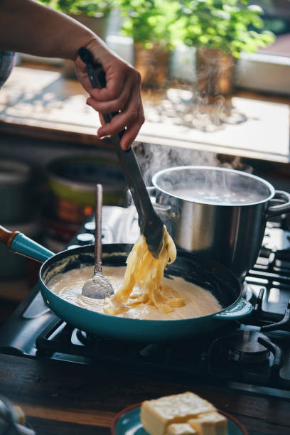 istock Preparing Fettuccine Pasta Alfredo with Parmesan 1387714111