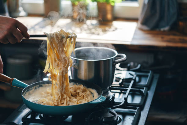istock Preparing Fettuccine Pasta Alfredo with Parmesan 1387714117
