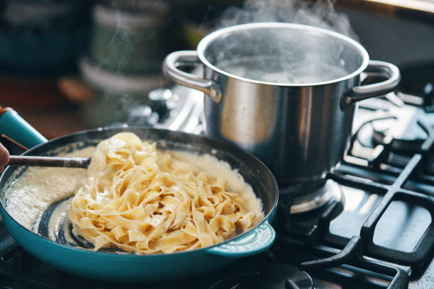istock Preparing Fettuccine Pasta Alfredo with Parmesan 1387714118
