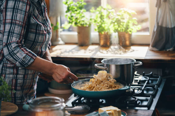 istock Preparing Fettuccine Pasta Alfredo with Parmesan 1387714121