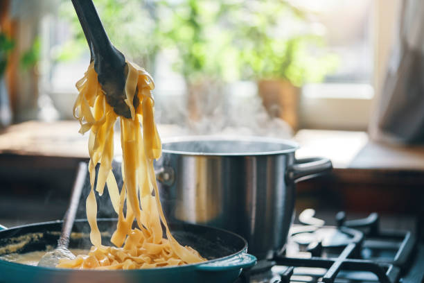 istock Preparing Fettuccine Pasta Alfredo with Parmesan 1387714123