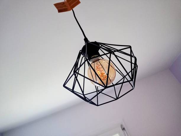 istock Photograph of a modern industrial style ceiling light with decorative bulbs 1387715265