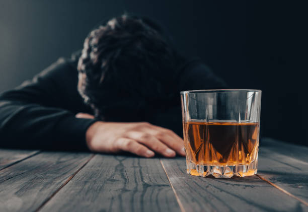 istock sad man with glass of alcohol 1387717136