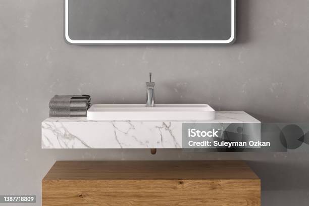 Close Up Of Sink With Square Mirror Standing In On Grey Wal Stock Photo - Download Image Now