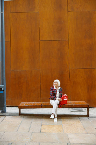 istock Beautiful senior woman thinking outdoors in town 1387719814