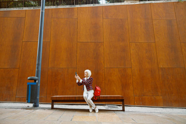 istock Happy elderly woman taking walk in city 1387719852